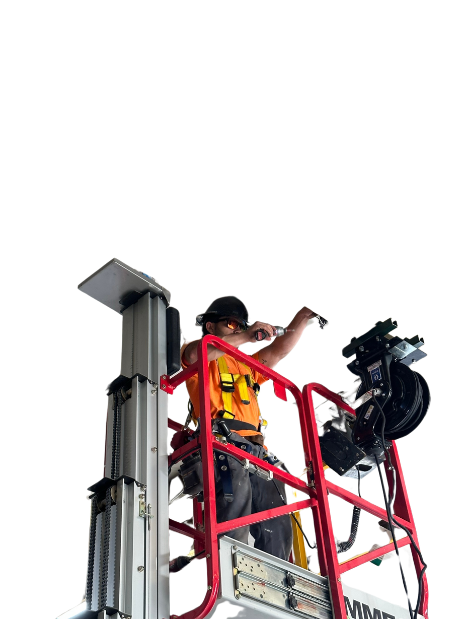 a General contractor on a scissor lift working on to install piece of equipment for HERC RENTALS. Completed by K-RAY CONSTRUCTION.