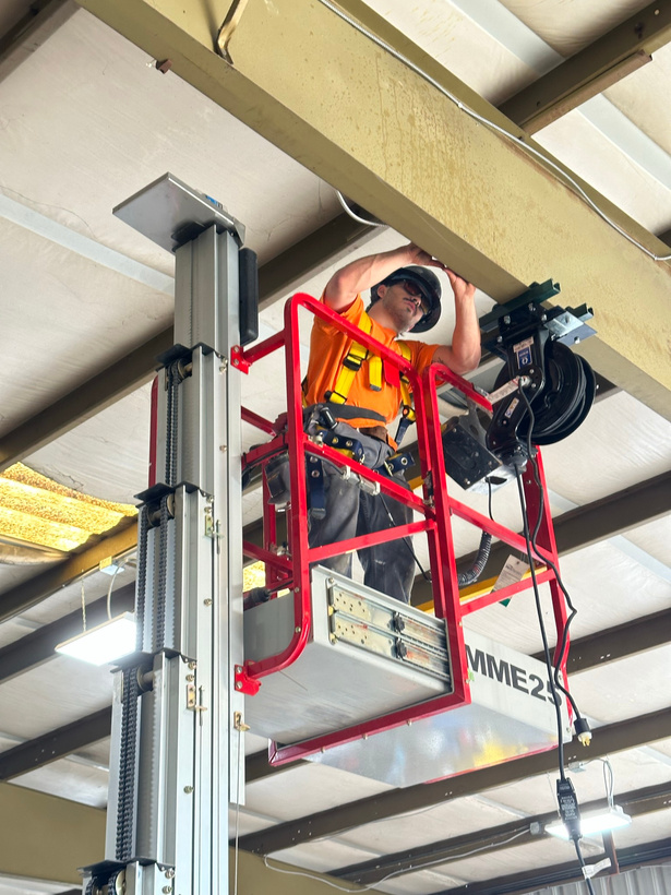 a contractor is working on a lift in a commerical building